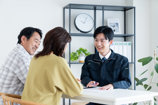 営業マンと話す中年夫婦